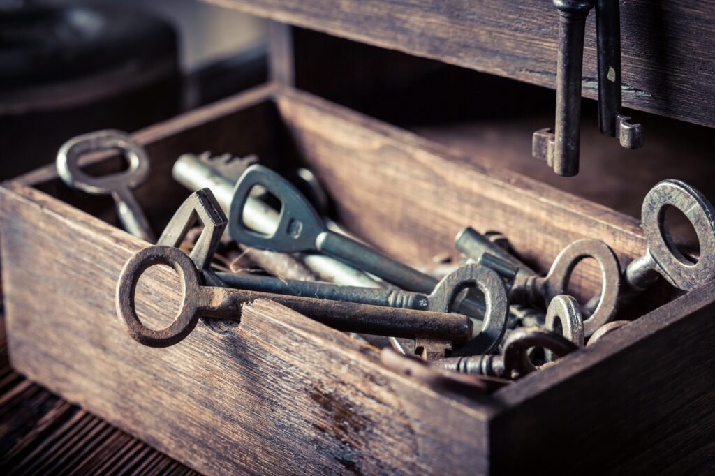 Old keys in wooden box in locksmiths workshop